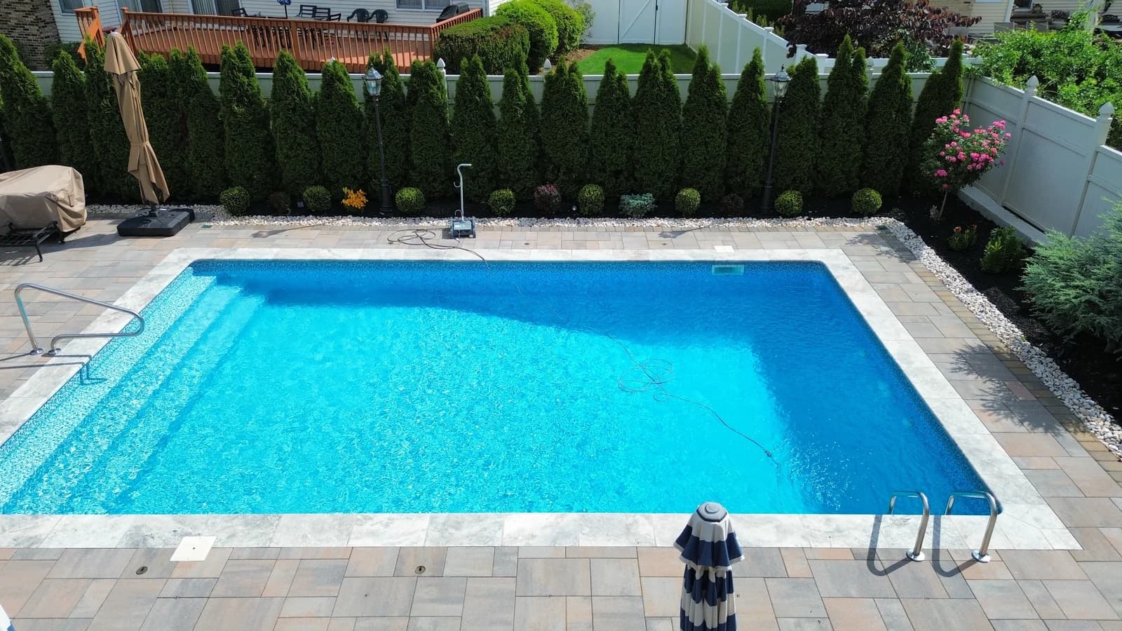 Overhead drone shot of a finished paver patio and walkway masonry installation by Father & Sons in NJ