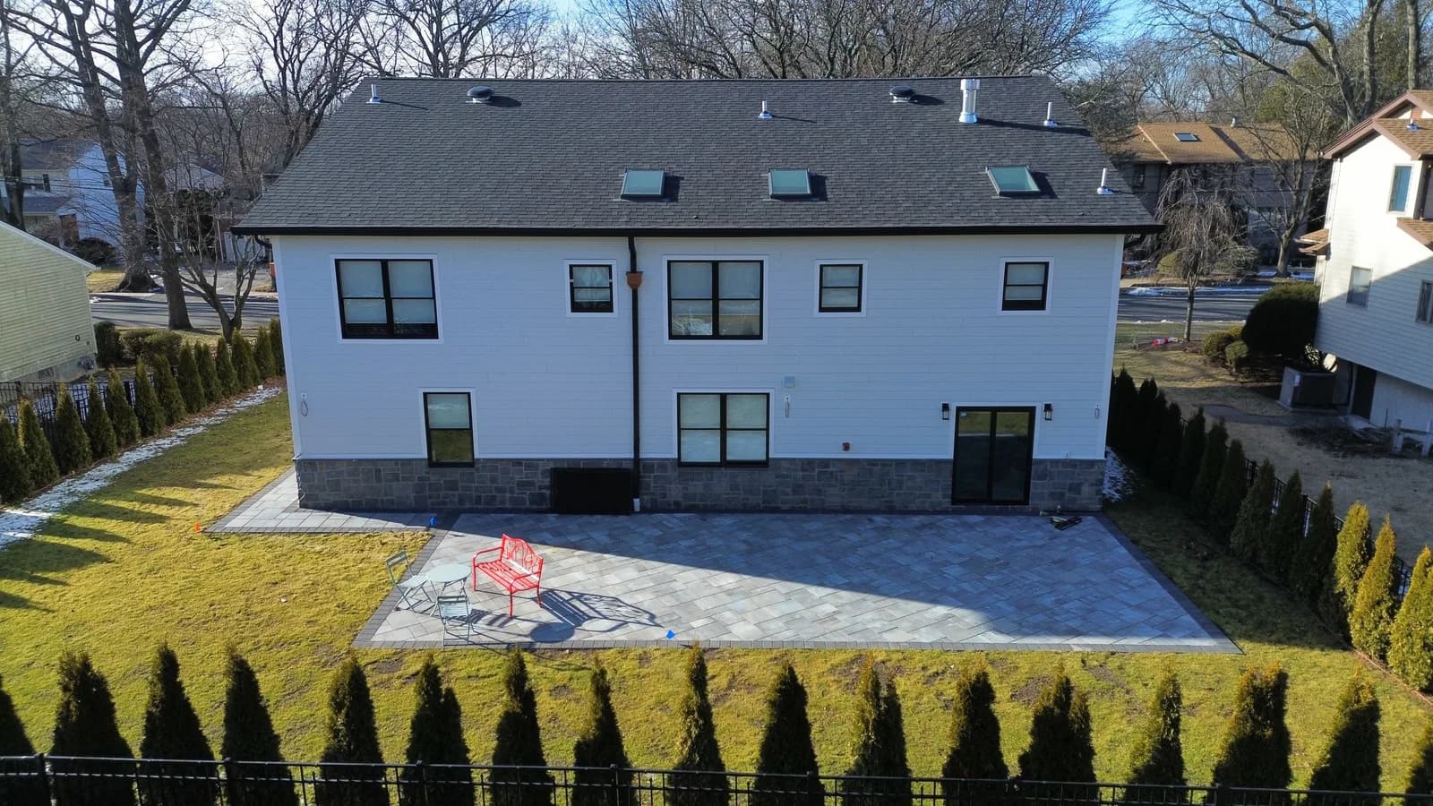 Drone view of a New Jersey home roof showing skylights set into new shingles