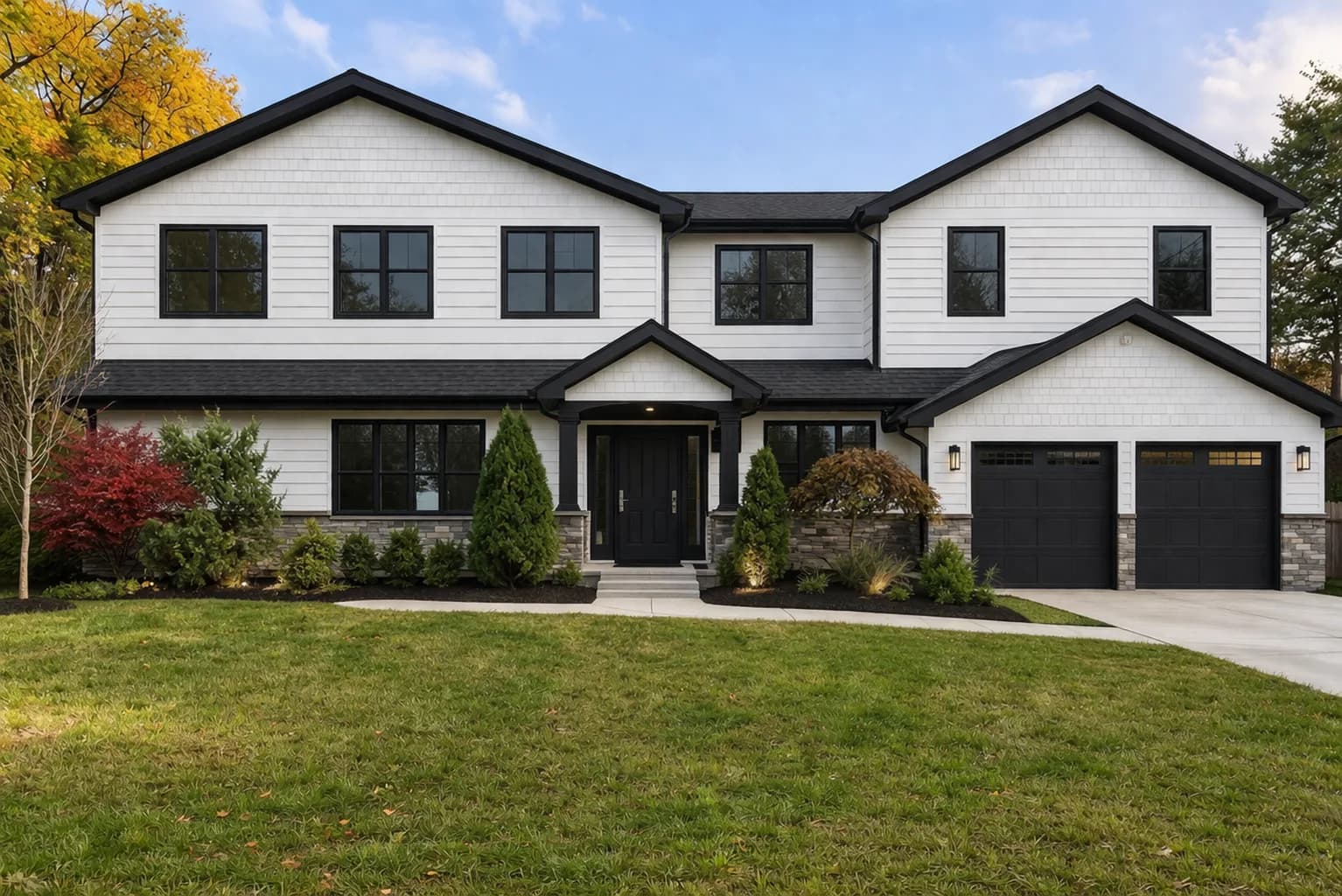Modern New Jersey home with white board-and-batten siding and stone veneer accents by Father & Sons
